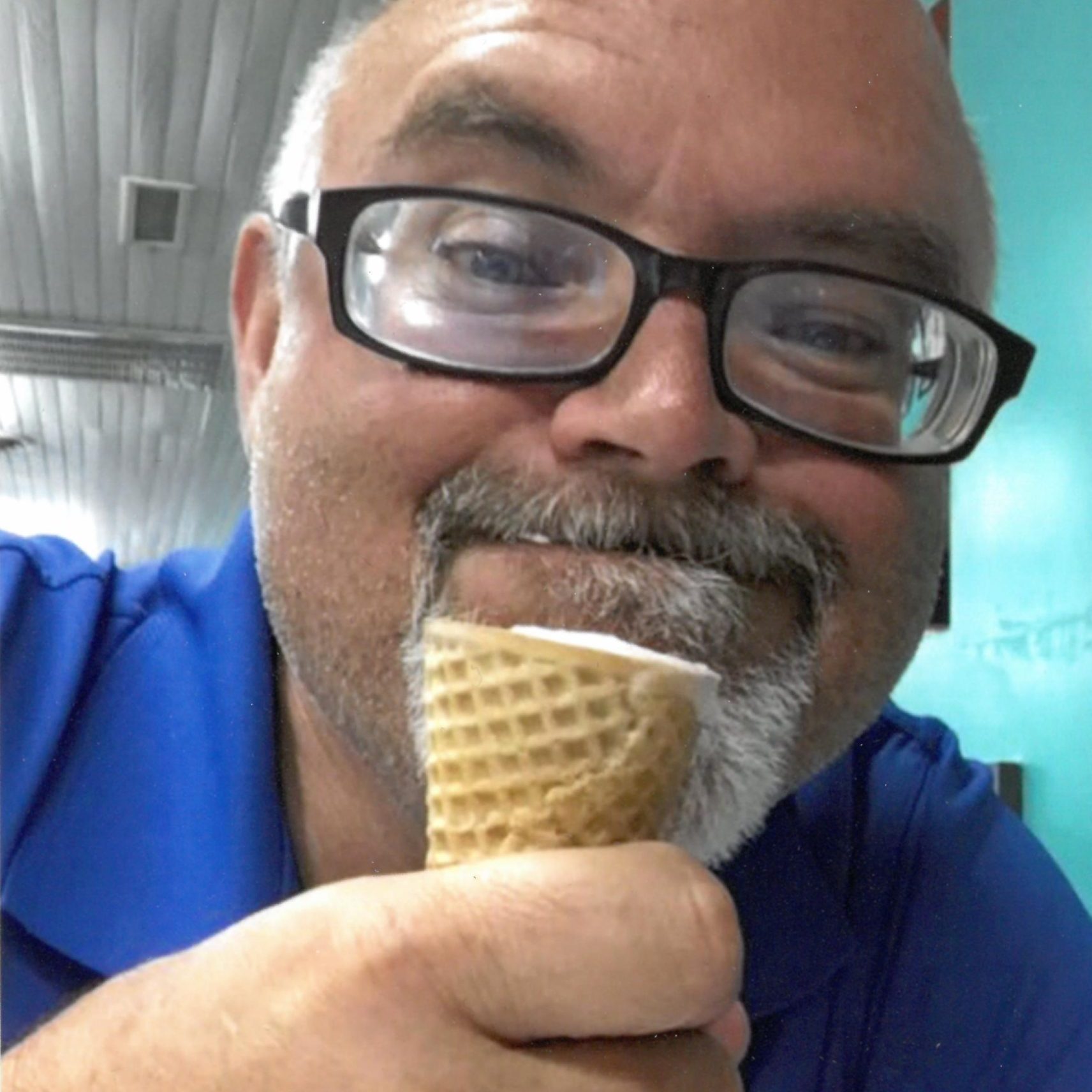 Middle aged man smiling while eating ice cream
